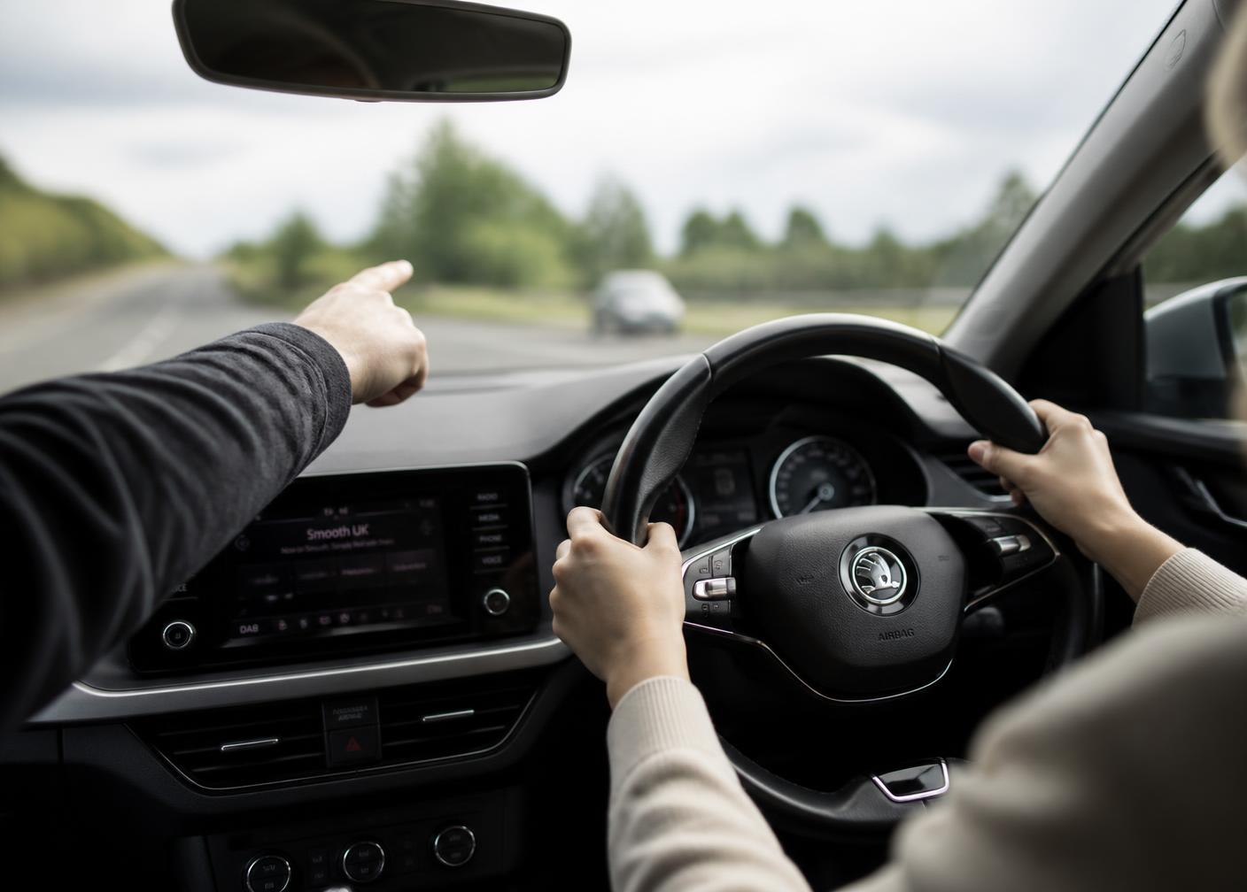 Instructor guiding a learner driver during a mock driving test
